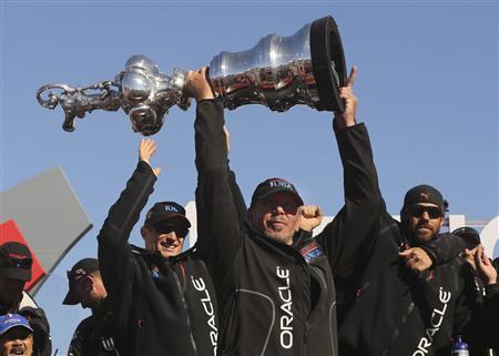 Oracle CEO Larry Ellison lifts the America's Cup with members of the Oracle Team USA after winning the overall title of the 34th America's Cup yacht sailing race over Emirates Team New Zealand in San Francisco
